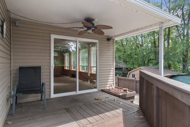 wooden deck with a ceiling fan