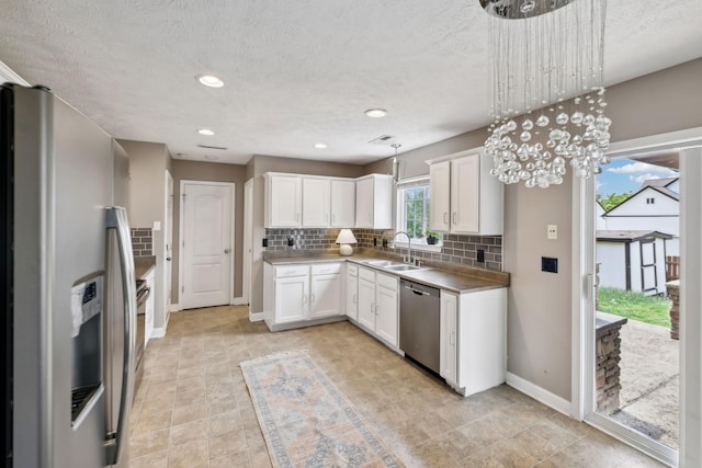 325 Golfview Ln, Springfield, TN 37172 - kitchen with stainless steel appliances, a sink, tasteful backsplash, white cabinetry, and baseboards