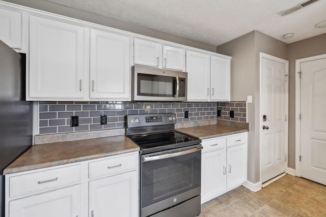 325 Golfview Ln, Springfield, TN 37172 - kitchen featuring appliances with stainless steel finishes, white cabinetry, and tasteful backsplash