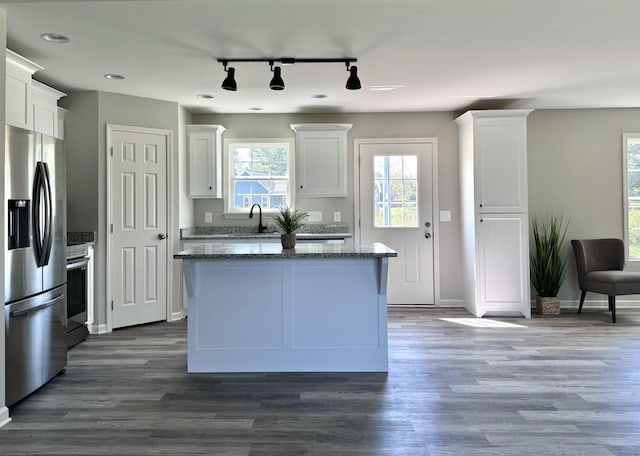 62 Sundance Dr, Lawrenceburg, TN 38464 - kitchen featuring stainless steel fridge, track lighting, range, dark stone counters, and a center island