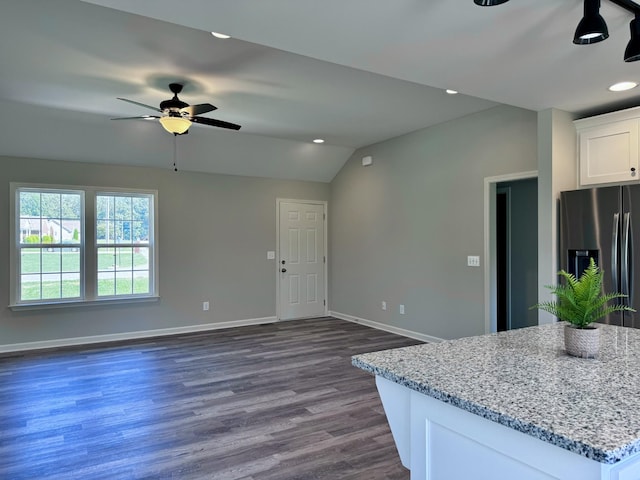 62 Sundance Dr, Lawrenceburg, TN 38464 - kitchen featuring stainless steel fridge, white cabinetry, baseboards, open floor plan, and vaulted ceiling