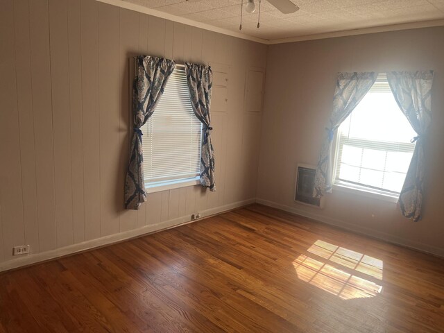 207 Powell St, Decherd, TN 37324 - empty room featuring wood finished floors, baseboards, ceiling fan, and ornamental molding