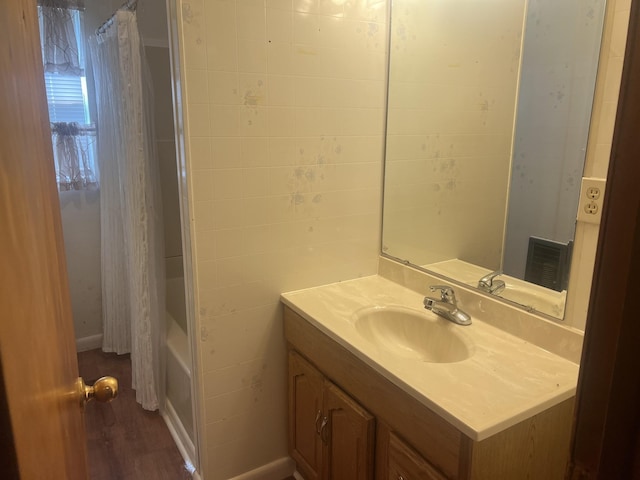 207 Powell St, Decherd, TN 37324 - bathroom featuring vanity, wood finished floors, and shower / bath combo