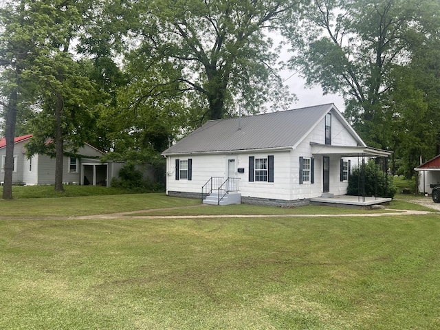 207 Powell St, Decherd, TN 37324 - view of front facade featuring a front yard, metal roof, and crawl space