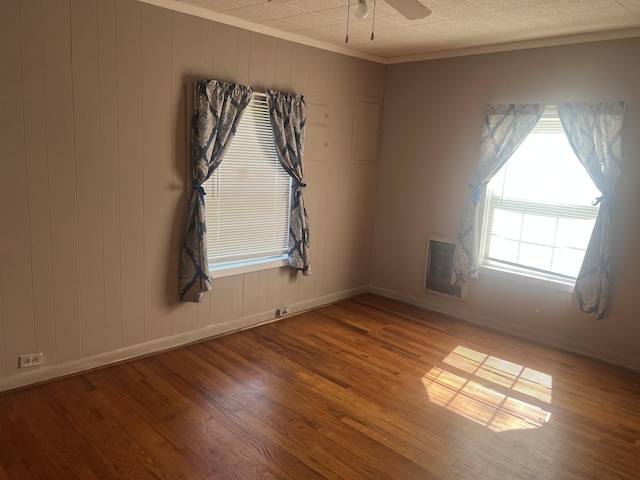 207 Powell St, Decherd, TN 37324 - empty room featuring wood finished floors, baseboards, ceiling fan, and ornamental molding