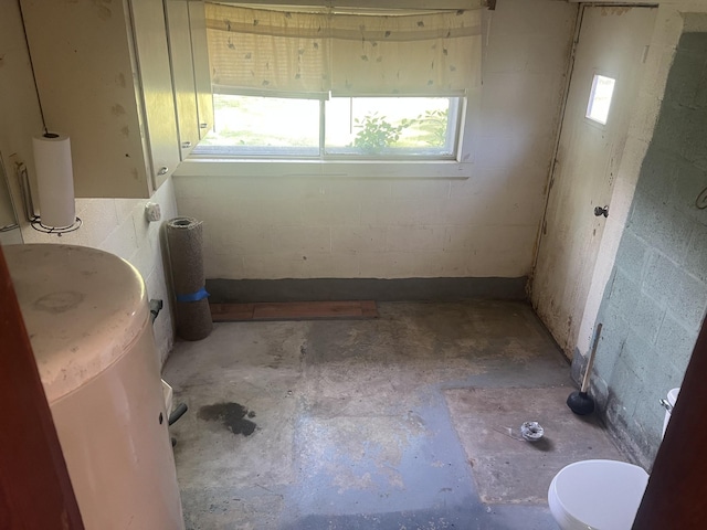 207 Powell St, Decherd, TN 37324 - bathroom with concrete floors, concrete block wall, and toilet