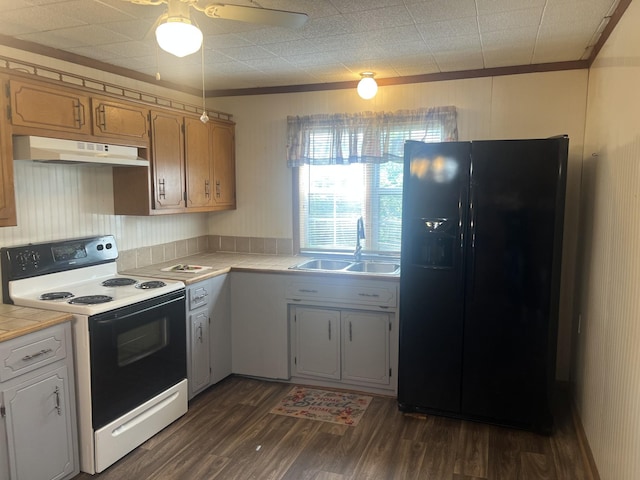 207 Powell St, Decherd, TN 37324 - kitchen featuring black fridge, range with electric stovetop, tile countertops, a sink, and under cabinet range hood