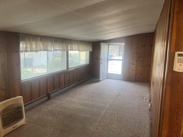207 Powell St, Decherd, TN 37324 - unfurnished room with vaulted ceiling, carpet floors, wood walls, and baseboard heating