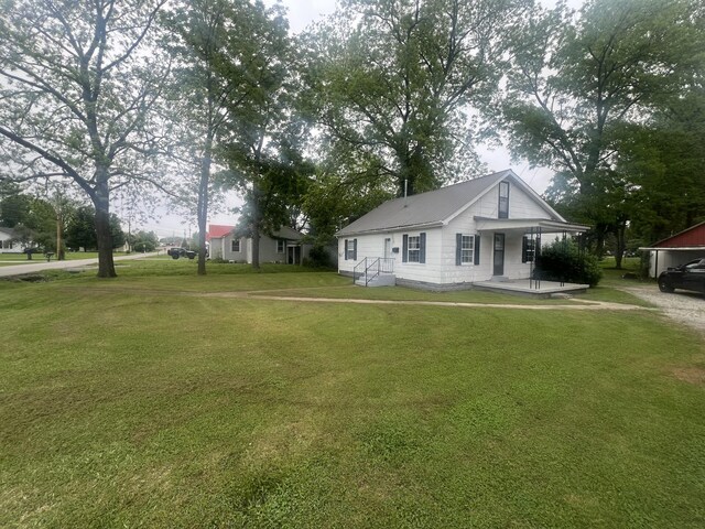 207 Powell St, Decherd, TN 37324 - view of front of house with a front yard and metal roof
