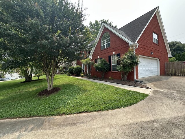 6900 Snow View Ln, Ooltewah, TN 37363 - view of property exterior featuring brick siding, driveway, and an attached garage