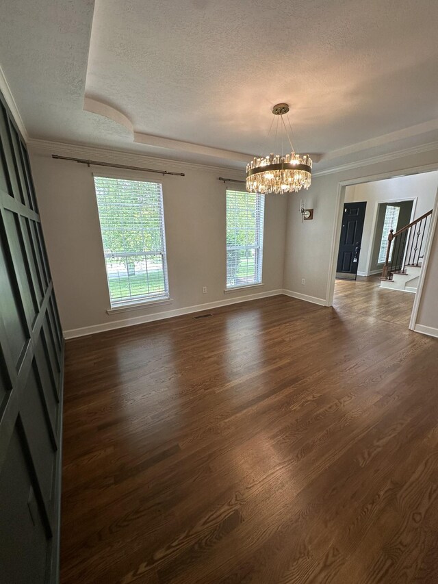 6900 Snow View Ln, Ooltewah, TN 37363 - spare room featuring a textured ceiling, dark wood finished floors, a chandelier, baseboards, and stairs