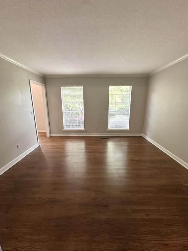 6900 Snow View Ln, Ooltewah, TN 37363 - empty room with a textured ceiling, ornamental molding, healthy amount of natural light, dark wood-style flooring, and baseboards