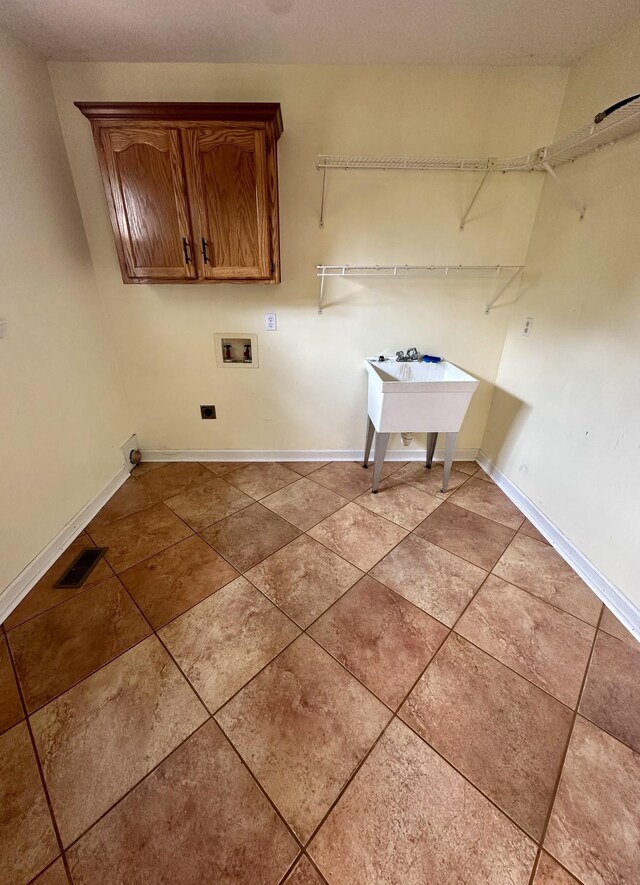 6900 Snow View Ln, Ooltewah, TN 37363 - washroom featuring cabinet space, washer hookup, baseboards, and light tile patterned flooring