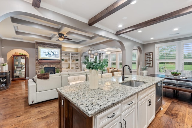 810 Pine Terrace Dr, Brentwood, TN 37027 - kitchen with a sink, a stone fireplace, arched walkways, ceiling fan, and light stone countertops