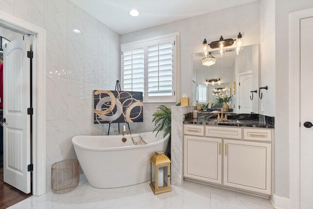 810 Pine Terrace Dr, Brentwood, TN 37027 - bathroom with a freestanding bath, marble finish floors, vanity, and tile walls