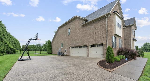 810 Pine Terrace Dr, Brentwood, TN 37027 - view of side of property featuring an attached garage, a lawn, concrete driveway, brick siding, and central air condition unit