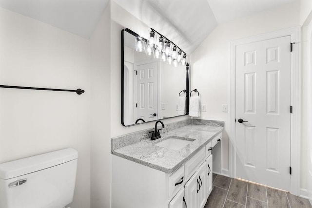 754 Veterans Pkwy, Murfreesboro, TN 37128 - bathroom featuring vanity, vaulted ceiling, toilet, and wood finished floors