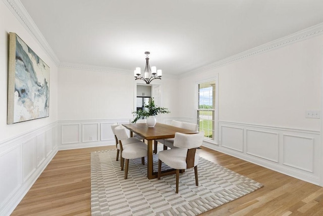 754 Veterans Pkwy, Murfreesboro, TN 37128 - dining room featuring a decorative wall, a chandelier, light wood-type flooring, ornamental molding, and wainscoting