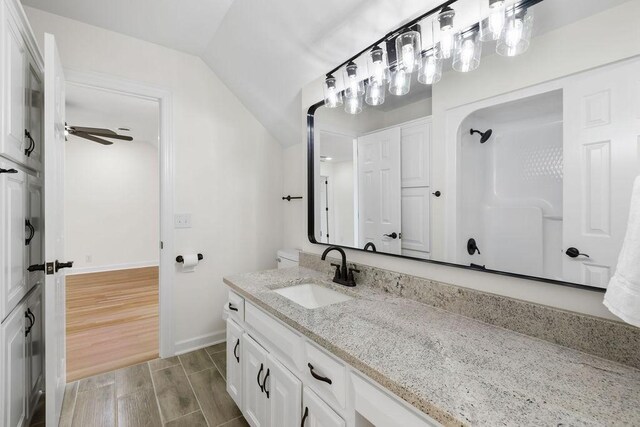 754 Veterans Pkwy, Murfreesboro, TN 37128 - bathroom featuring vanity, vaulted ceiling, wood finished floors, baseboards, and a shower