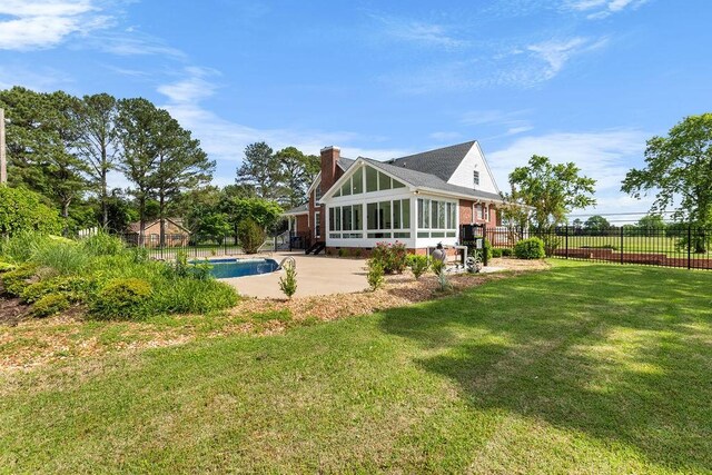 754 Veterans Pkwy, Murfreesboro, TN 37128 - rear view of house with a sunroom, a chimney, and a patio