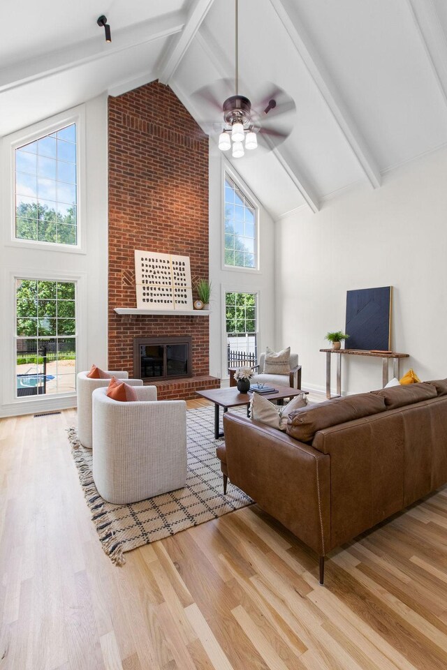 754 Veterans Pkwy, Murfreesboro, TN 37128 - living area featuring high vaulted ceiling, wood finished floors, a brick fireplace, a ceiling fan, and beamed ceiling