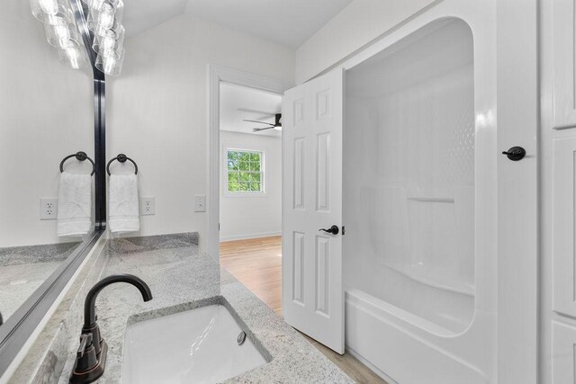 754 Veterans Pkwy, Murfreesboro, TN 37128 - bathroom with wood finished floors, a bathtub, vanity, and a ceiling fan