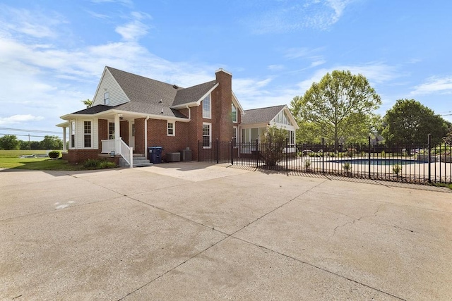 754 Veterans Pkwy, Murfreesboro, TN 37128 - view of property exterior featuring fence, brick siding, concrete driveway, a chimney, and cooling unit