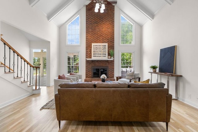 754 Veterans Pkwy, Murfreesboro, TN 37128 - living area with light wood-style flooring, high vaulted ceiling, a brick fireplace, beamed ceiling, and baseboards