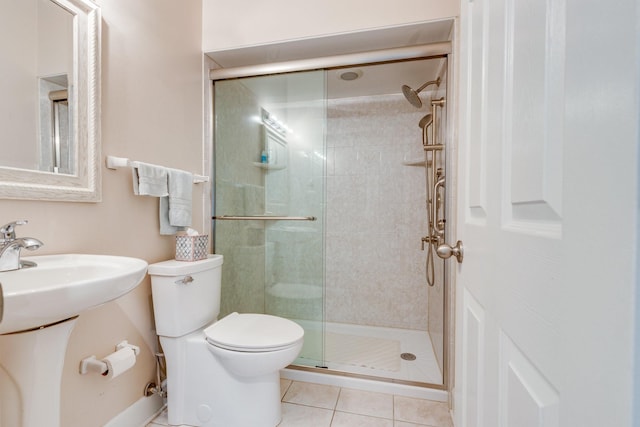 full bath with a shower stall, toilet, and tile patterned flooring