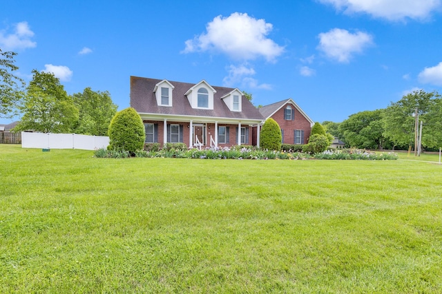 cape cod home featuring brick siding