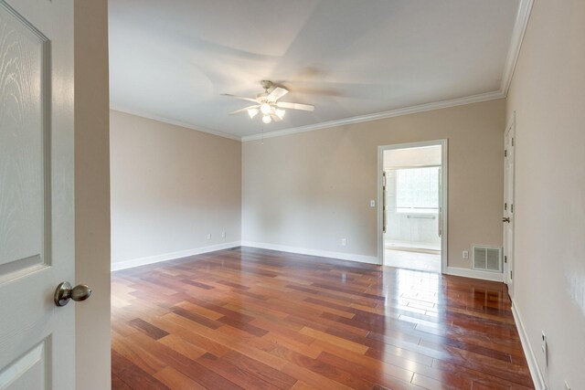 spare room featuring ceiling fan, hardwood / wood-style floors, crown molding, and baseboards