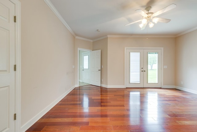 spare room featuring wood finished floors, ceiling fan, healthy amount of natural light, and ornamental molding