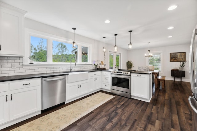 1244 Westfield Rd, Dickson, TN 37055 - kitchen with appliances with stainless steel finishes, a sink, a peninsula, dark countertops, and recessed lighting