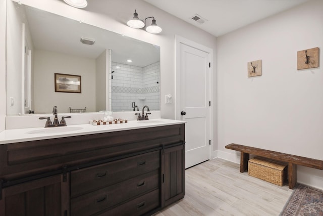 1244 Westfield Rd, Dickson, TN 37055 - full bath featuring double vanity, tiled shower, wood finished floors, and baseboards