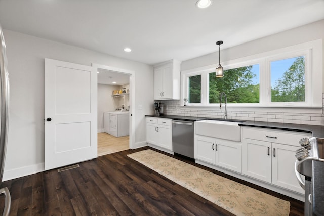 1244 Westfield Rd, Dickson, TN 37055 - kitchen featuring stainless steel appliances, washing machine and dryer, dark wood-style flooring, dark countertops, and recessed lighting