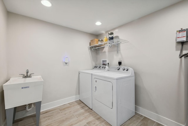 1244 Westfield Rd, Dickson, TN 37055 - washroom featuring washing machine and dryer, baseboards, light wood-style floors, and recessed lighting