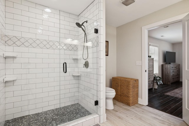 1244 Westfield Rd, Dickson, TN 37055 - full bathroom featuring toilet, a stall shower, wood finished floors, and baseboards
