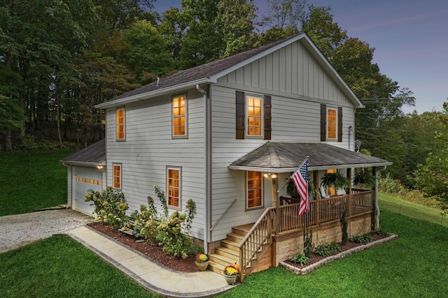 1244 Westfield Rd, Dickson, TN 37055 - view of front of house with covered porch, driveway, board and batten siding, a shingled roof, and a front lawn