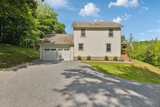 1244 Westfield Rd, Dickson, TN 37055 - view of property exterior featuring asphalt driveway, a garage, a yard, and covered porch