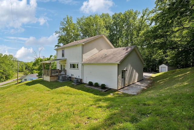 1244 Westfield Rd, Dickson, TN 37055 - back of property with a yard, central AC unit, and a shingled roof