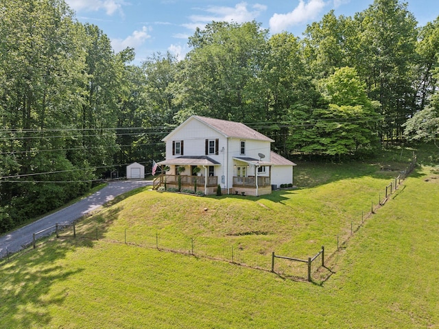 1244 Westfield Rd, Dickson, TN 37055 - back of house with an outdoor structure, covered porch, driveway, and a garage