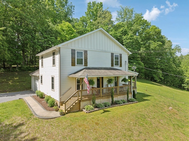 1244 Westfield Rd, Dickson, TN 37055 - view of front facade featuring a porch, driveway, board and batten siding, and a front lawn