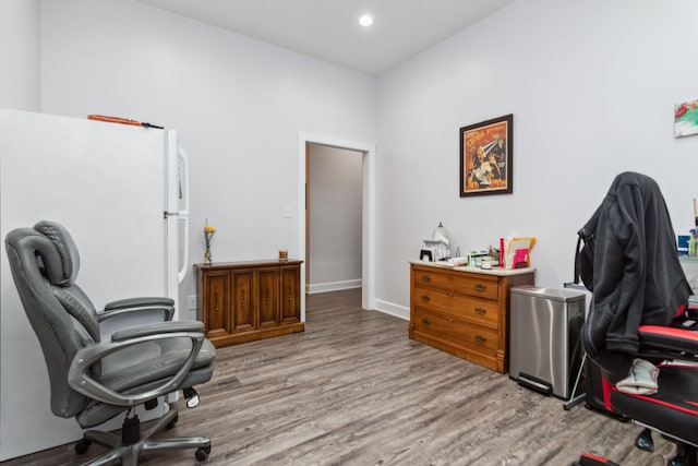 home office featuring wood finished floors, recessed lighting, and baseboards