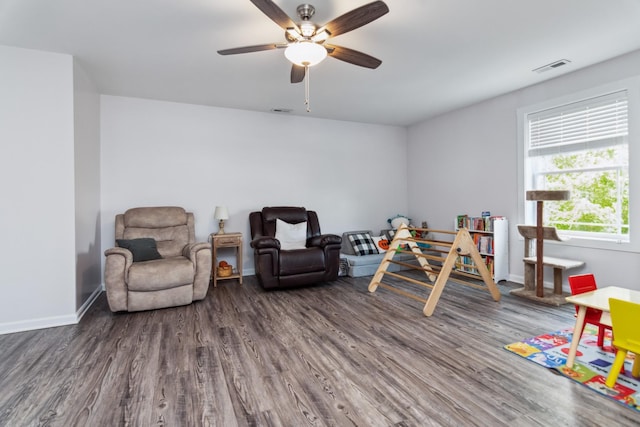 playroom with wood finished floors, ceiling fan, and baseboards