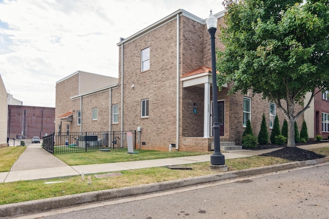 view of building exterior with fence