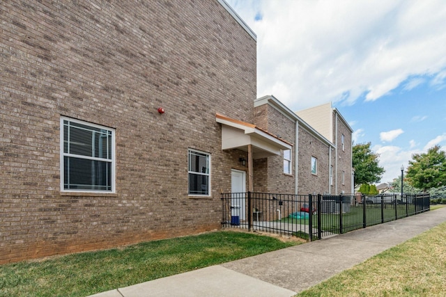 view of side of home with brick siding