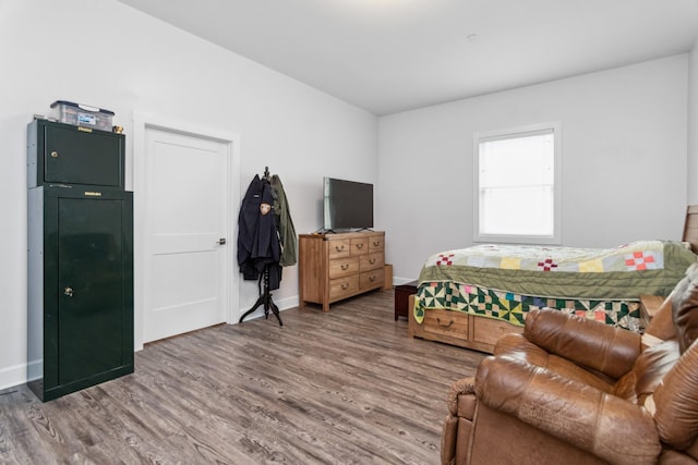 bedroom featuring wood finished floors and baseboards