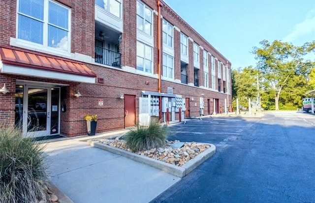 view of building exterior featuring uncovered parking
