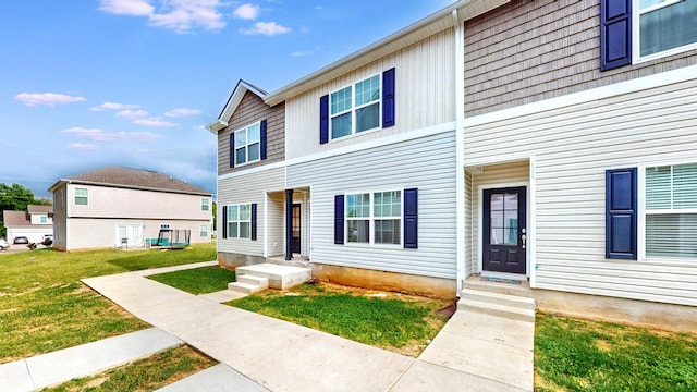 view of property featuring a front lawn