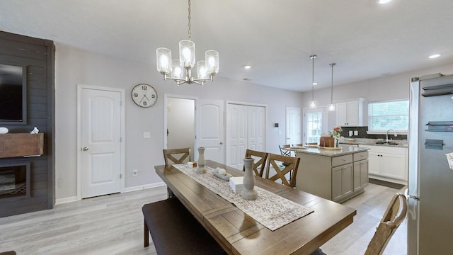 dining area featuring light wood-style floors, recessed lighting, a chandelier, and baseboards